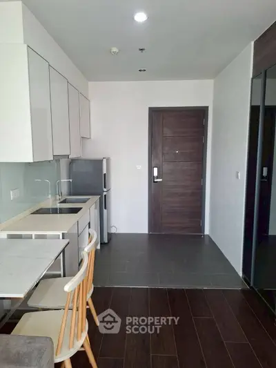 Modern kitchen with sleek cabinetry and compact design in a stylish apartment.