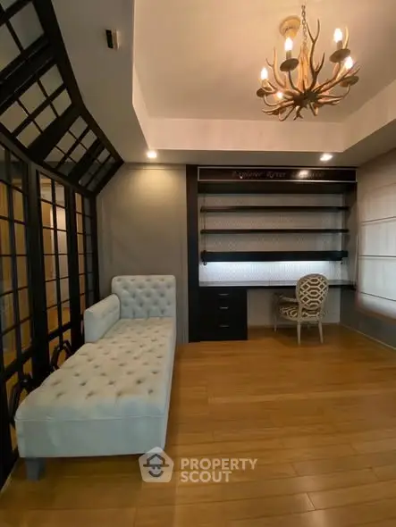 Elegant study room with stylish chandelier and cozy seating area