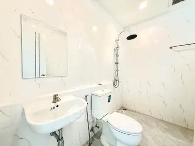 Modern bathroom with sleek white tiles and contemporary fixtures