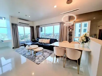 Spacious modern living room with city view, elegant decor, and open layout in luxury apartment.