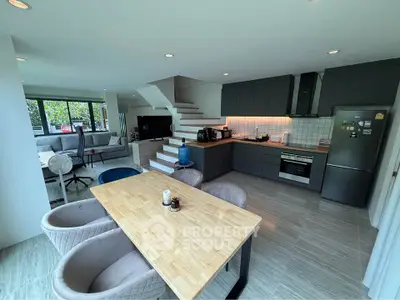 Spacious open-plan kitchen and living area with modern design and natural light.