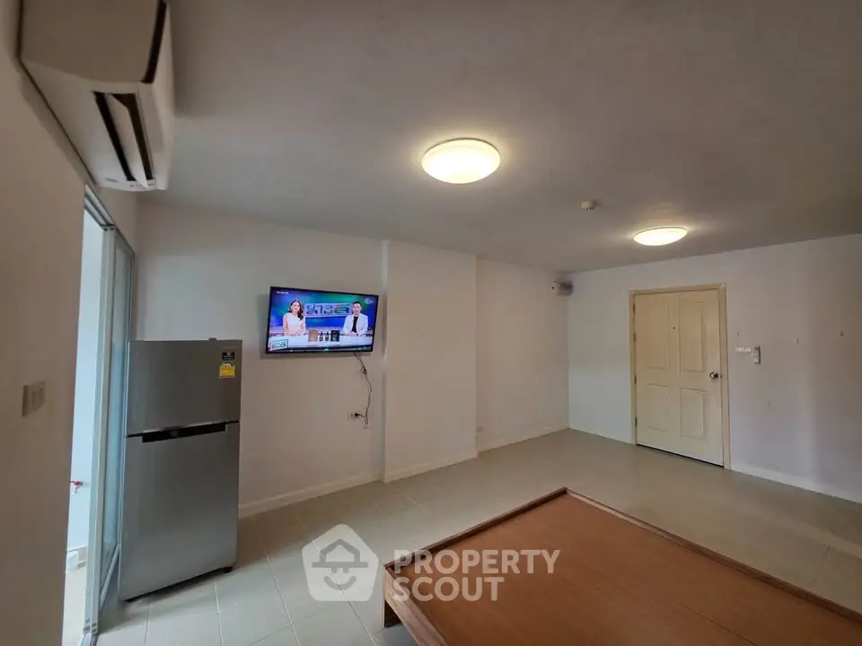 Spacious living room with modern appliances and minimalist design