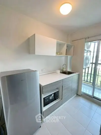 Modern kitchen with sleek appliances and balcony view