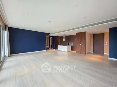 Spacious modern living room with open kitchen and elegant design.