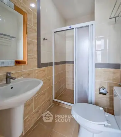 Modern bathroom with sleek shower and elegant fixtures in a stylish real estate property.