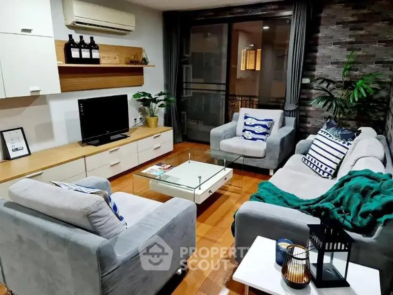 Stylish living room with modern decor, cozy seating, and elegant wooden flooring.