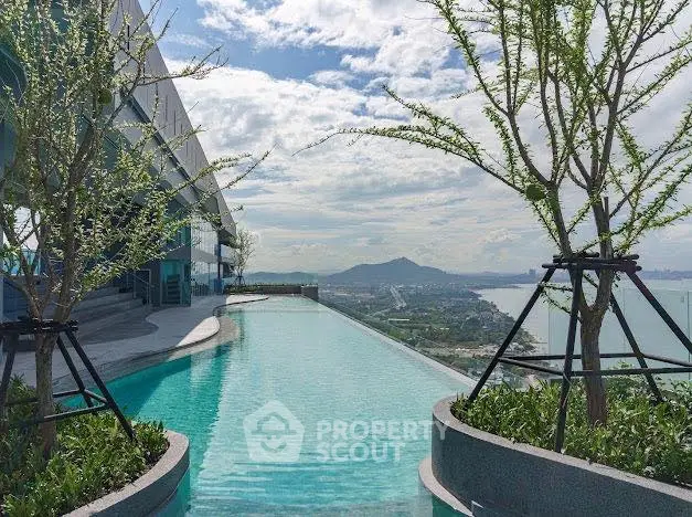 Stunning rooftop infinity pool with panoramic city and ocean views.