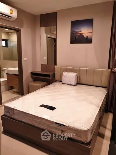 Modern bedroom with ensuite bathroom and stylish decor in a cozy apartment.