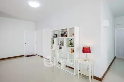 Spacious modern living room with sleek white shelving and elegant decor