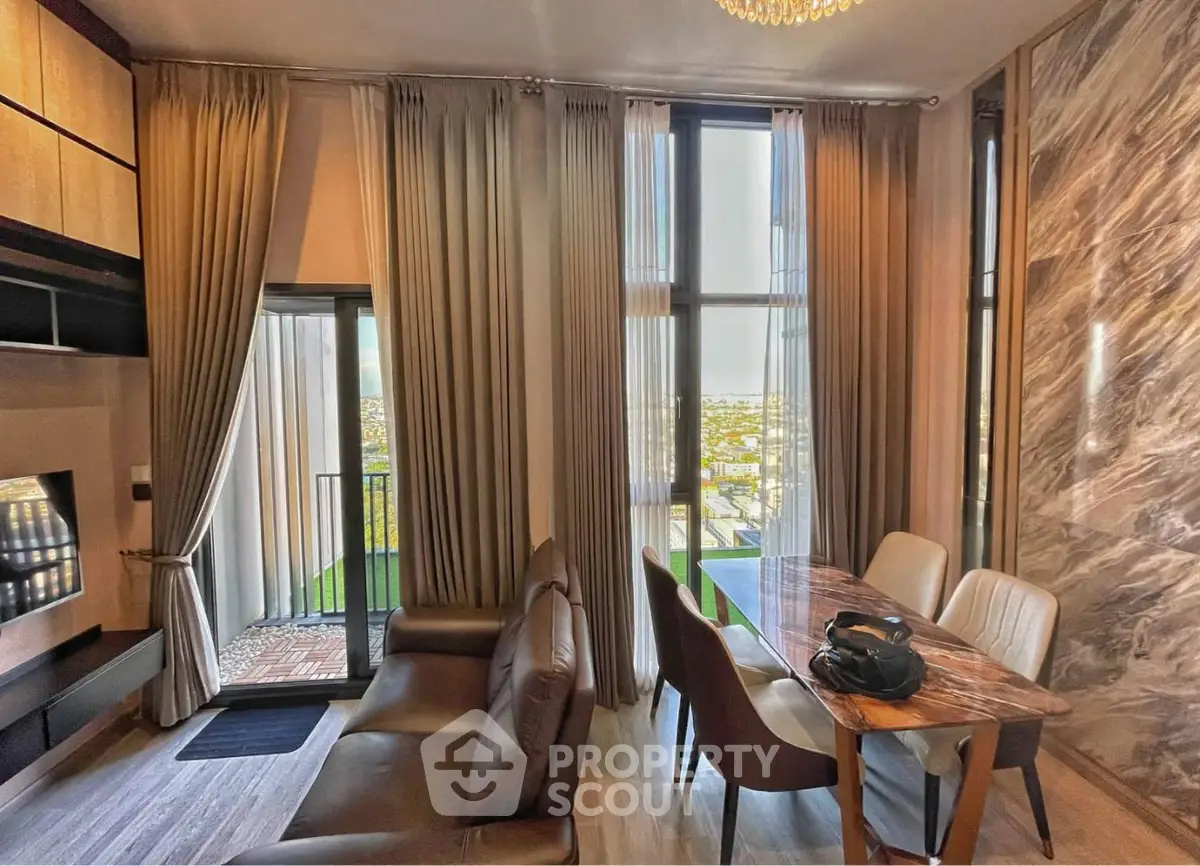 Luxurious living room with high ceilings, elegant curtains, and a stunning city view from the balcony.