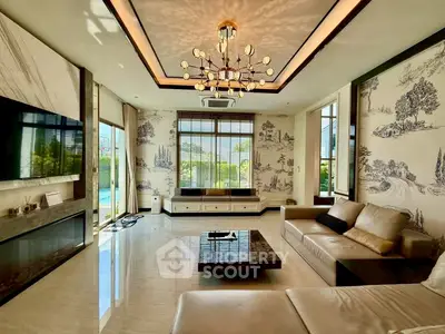 Luxurious living room with elegant chandelier and scenic wallpaper, featuring modern furniture and large windows.