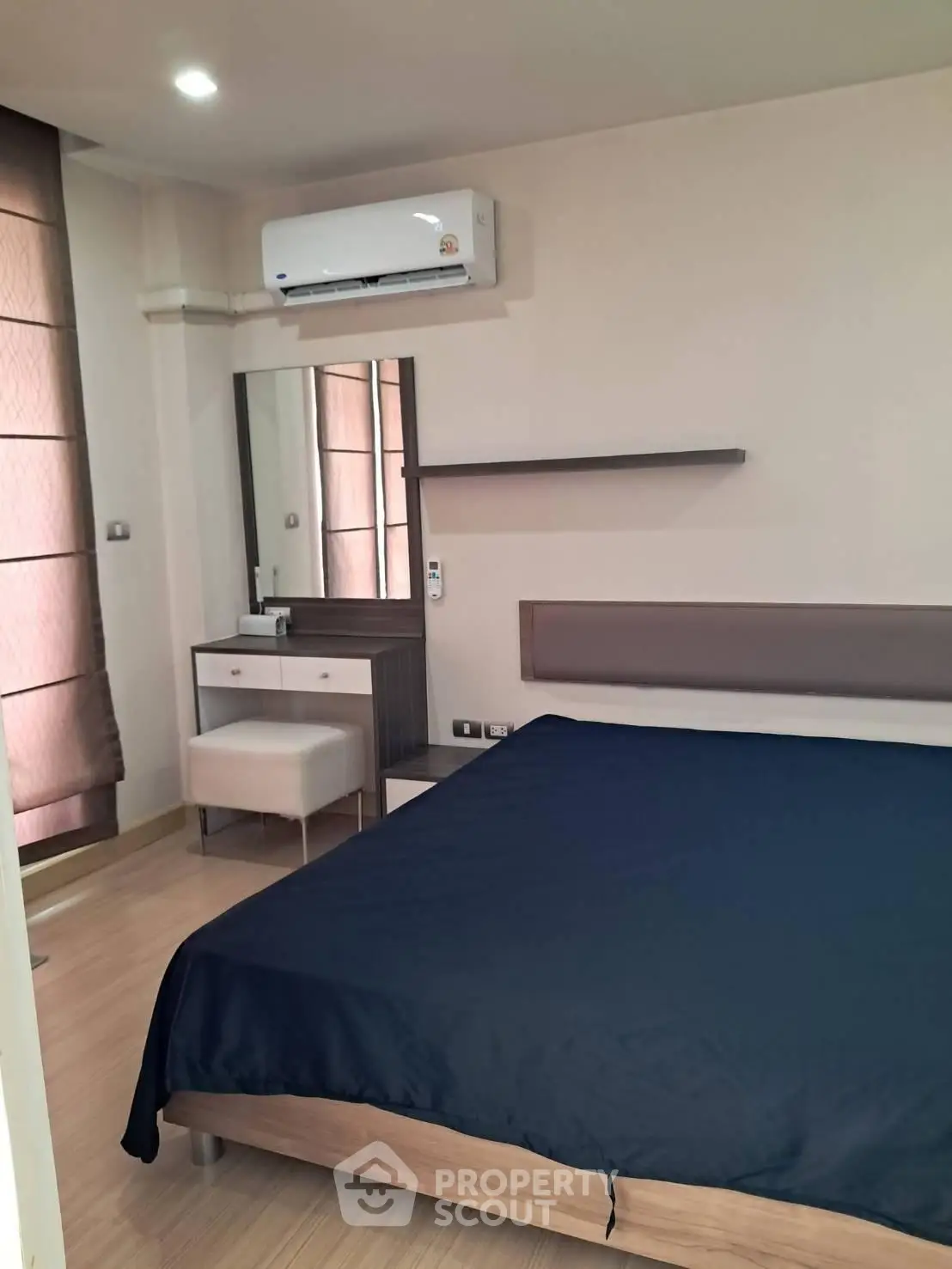 Modern bedroom with sleek furniture and air conditioning in a stylish apartment.