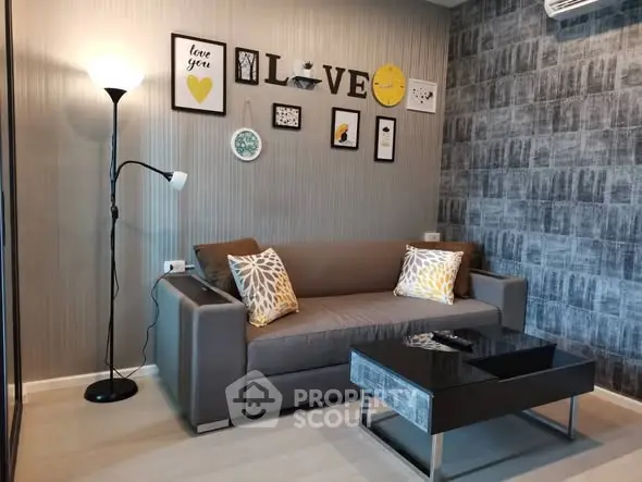 Stylish living room with modern decor and cozy sofa, perfect for relaxation and entertaining guests.