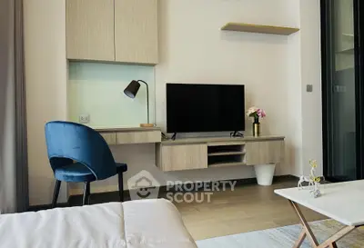 Modern living room with sleek TV setup and stylish blue chair