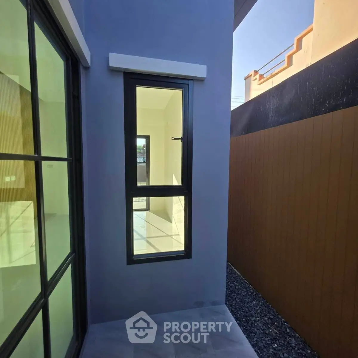 Modern exterior view of a sleek building with large windows and minimalist design.