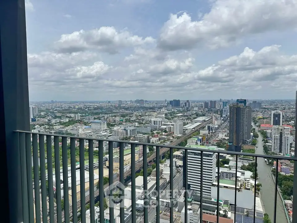 Stunning cityscape view from a high-rise balcony, showcasing urban skyline and expansive horizon.