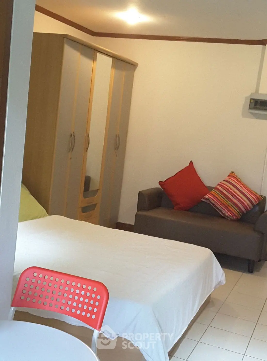 Cozy bedroom with modern furniture and colorful accents in a stylish apartment.