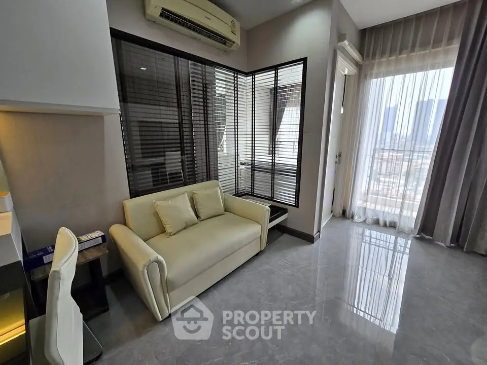 Modern living room with sleek design and city view, featuring a cozy sofa and large windows.