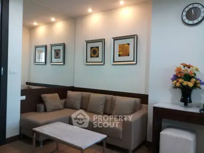 Stylish living room with modern decor, featuring a cozy sofa, elegant wall art, and ambient lighting.