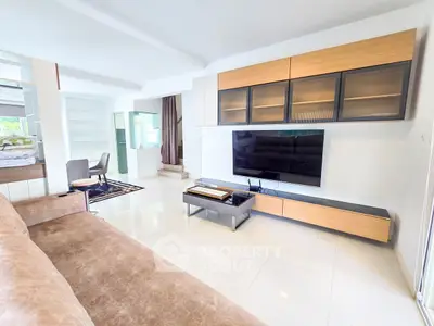 Spacious modern living room with sleek TV setup and elegant furnishings