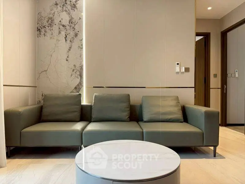 Modern living room with sleek sofa and marble accents