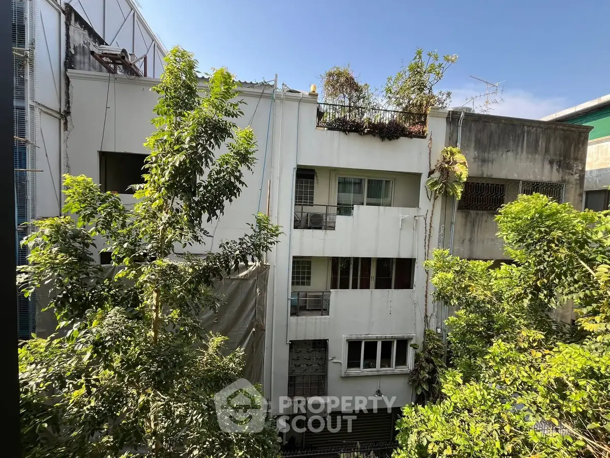 Charming urban residential building with lush greenery and natural light