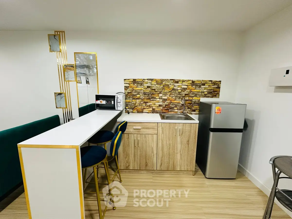Modern kitchen with sleek bar seating and stylish backsplash