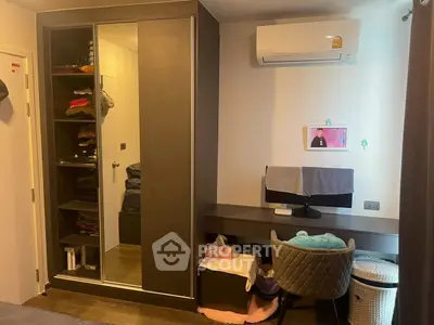 Cozy bedroom with built-in wardrobe and modern desk setup, ideal for comfortable living.