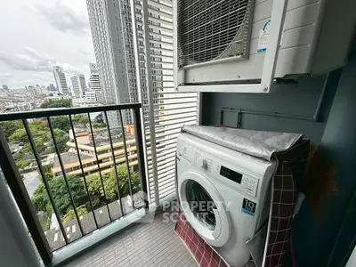 High-rise balcony with washing machine and city view