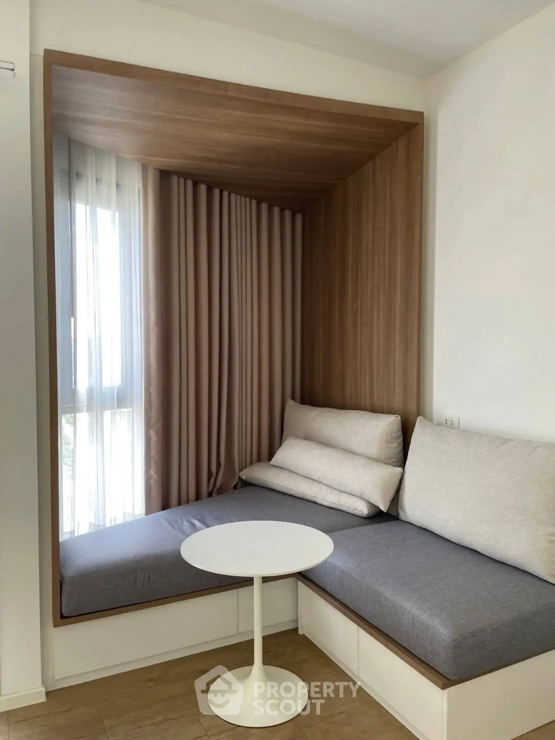 Cozy nook with built-in seating and modern table in bright apartment corner