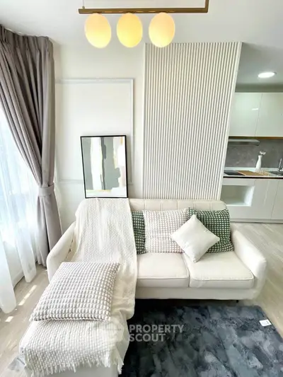 Modern living room with cozy white sofa and elegant decor