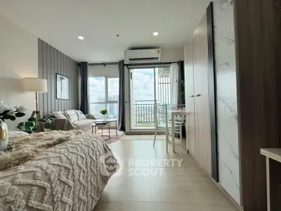 Chic studio apartment with cozy living area and balcony view