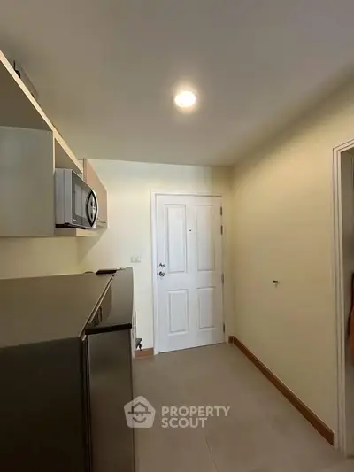 Compact kitchen area with modern appliances and sleek design