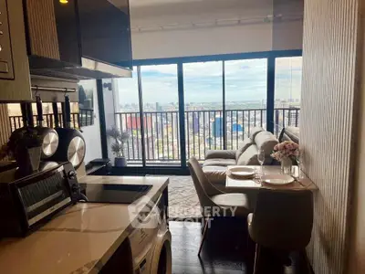 Modern apartment with open kitchen and stunning city view from balcony.