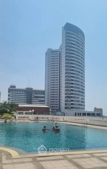 Stunning high-rise building with poolside view, perfect for luxury living.