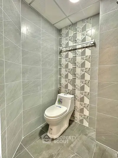 Modern bathroom with stylish tile design and sleek toilet fixture.