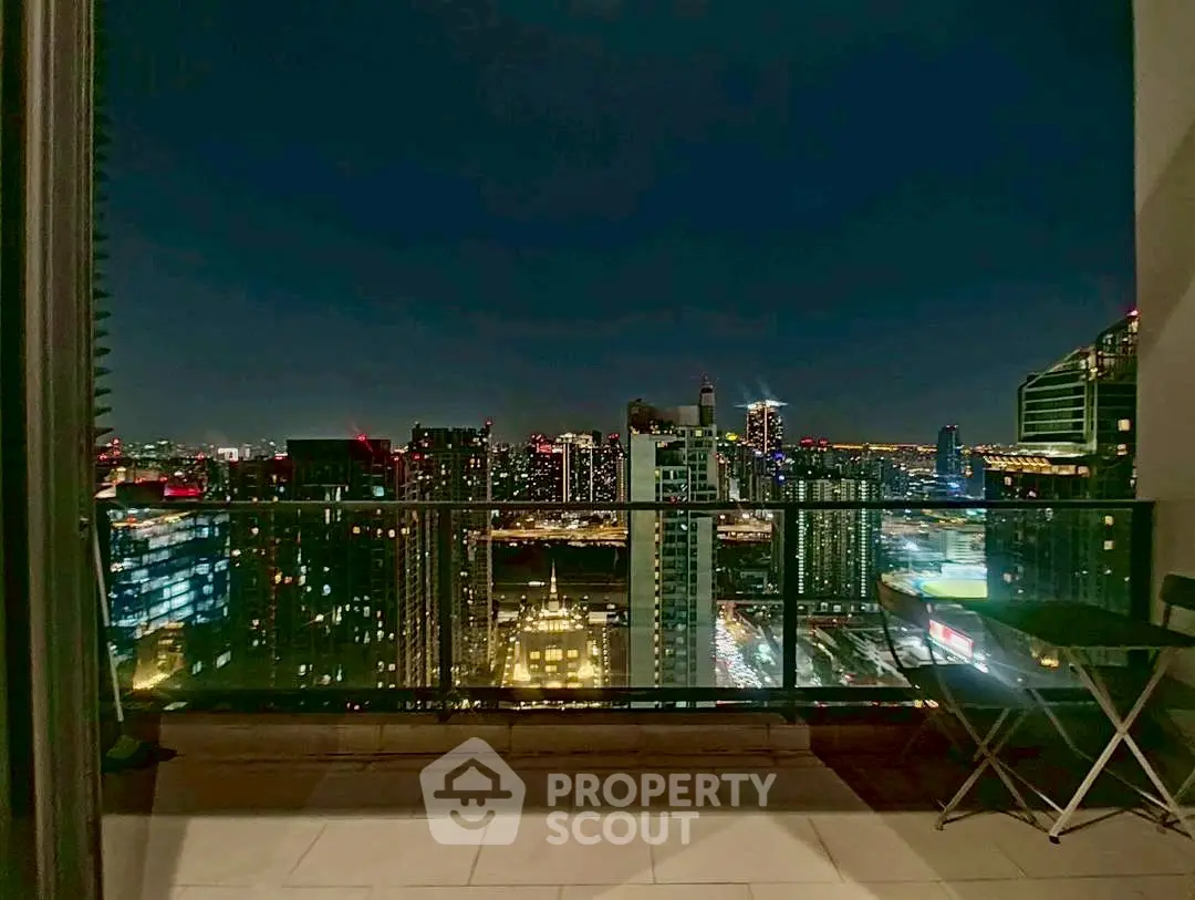 Stunning city skyline view from a high-rise balcony at night.