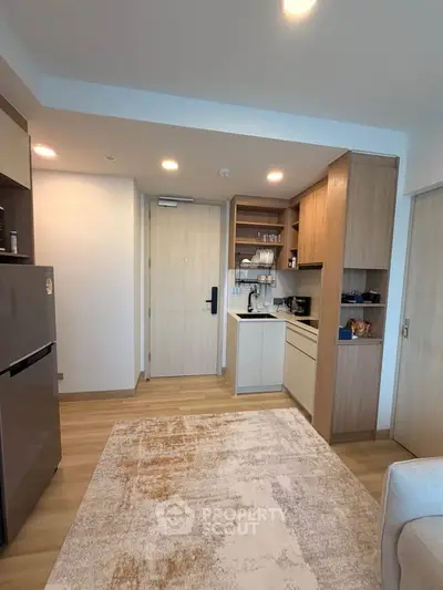 Modern kitchen with open layout and sleek appliances in cozy apartment