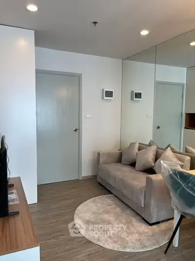 Modern living room with cozy sofa and stylish decor in a contemporary apartment.