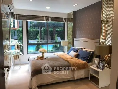 Luxurious bedroom with pool view and elegant decor, featuring large windows and stylish furnishings.