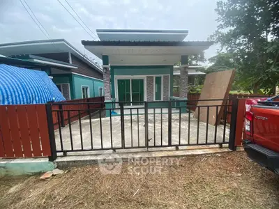 Modern single-story house with a fenced front yard and contemporary design.