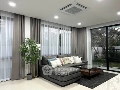 Luxurious modern living room with plush sectional sofa and garden view