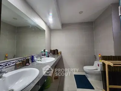 Spacious bathroom with dual sinks and modern fixtures in a stylish home.
