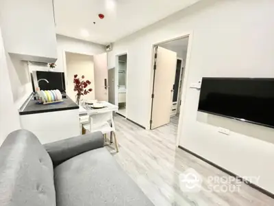 Modern apartment interior with sleek design and open layout, featuring a cozy living area and stylish kitchen.