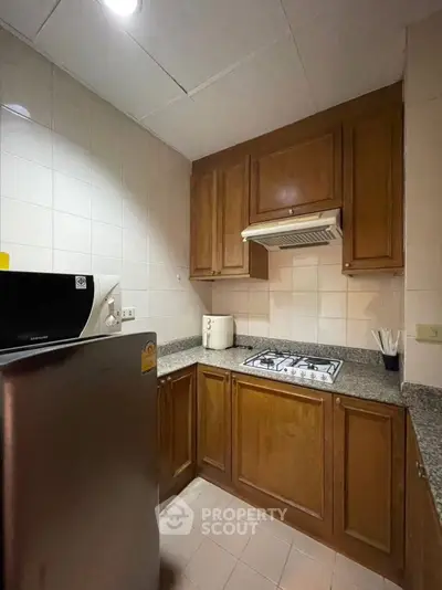 Cozy kitchen with wooden cabinets and modern gas stove