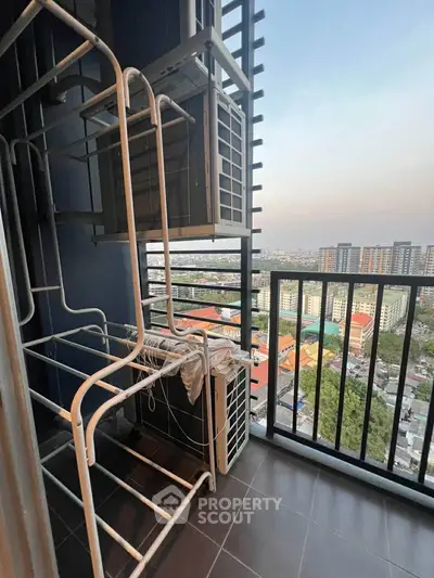 High-rise balcony with city view and laundry rack, perfect for urban living.