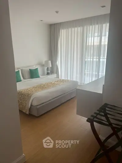Spacious bedroom with elegant decor and natural light