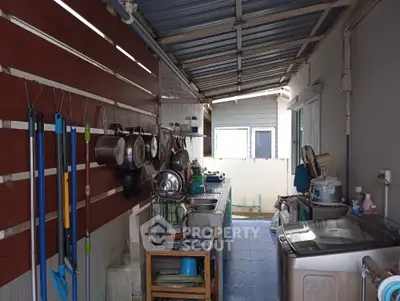 Functional outdoor kitchen with washing machine and cookware storage