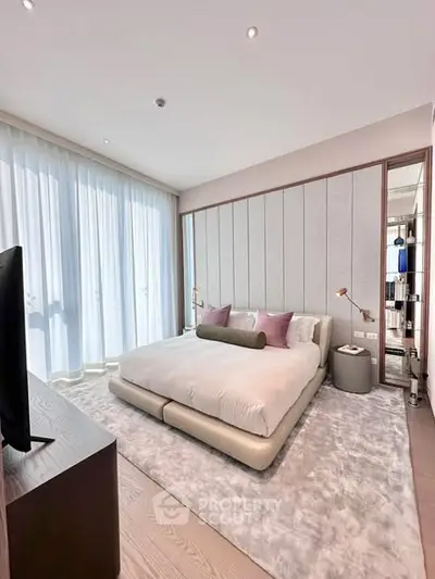 Luxurious bedroom with modern decor and large windows in a high-end apartment.