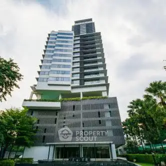 Modern high-rise building with unique architectural design and lush greenery.